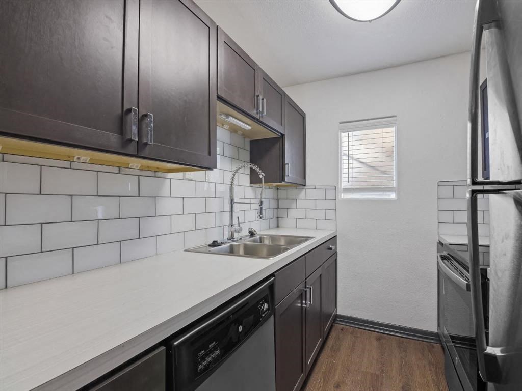 a kitchen with a sink and a refrigerator