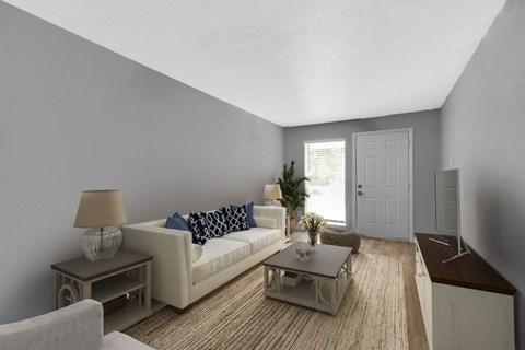 A living room with a white couch and a coffee table.