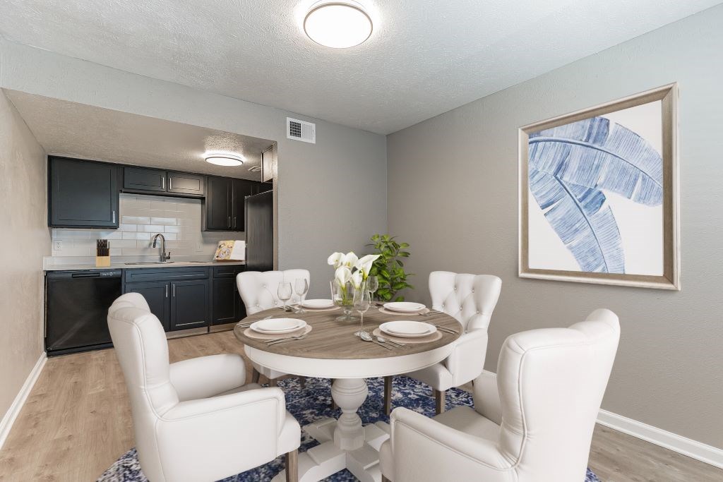 A dining room with a round table and chairs.