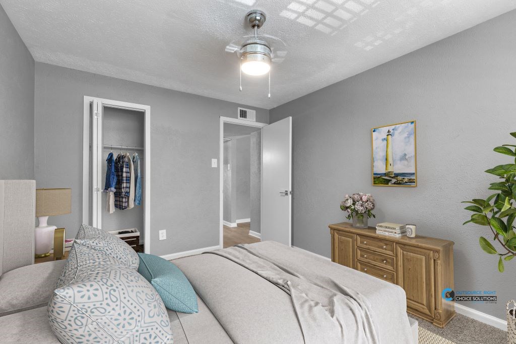 A bedroom with a bed, dresser, and closet.