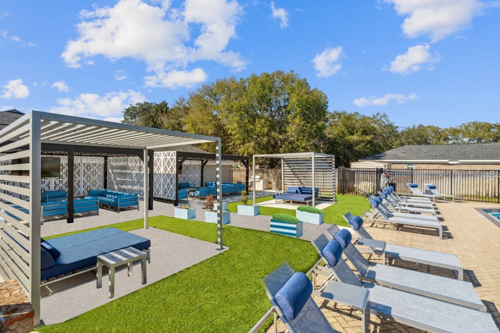 a resort style pool with lounge chairs and tables