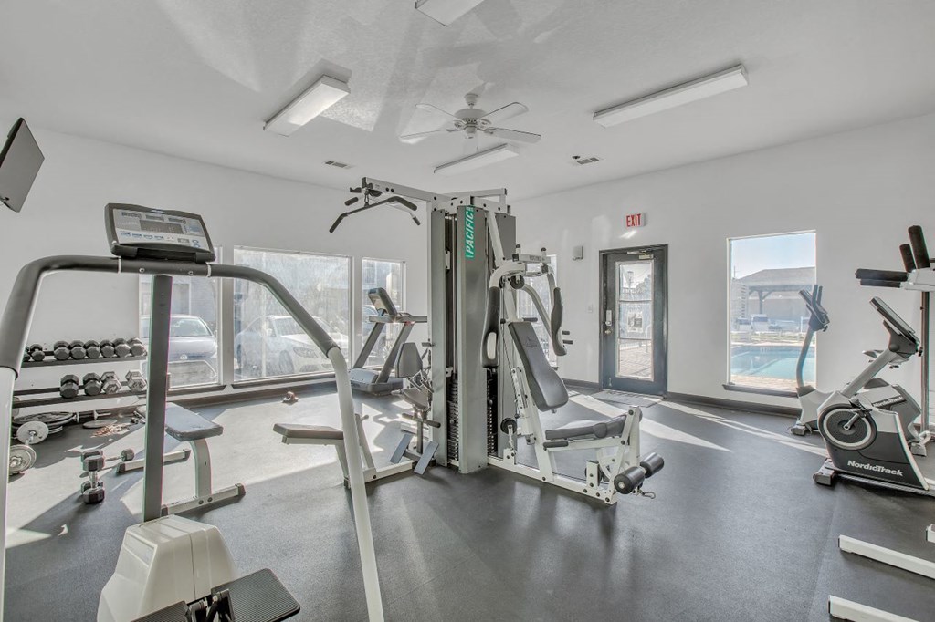 a gym with weights and a view of the ocean