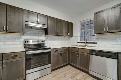 a kitchen with stainless steel appliances and wooden cabinets