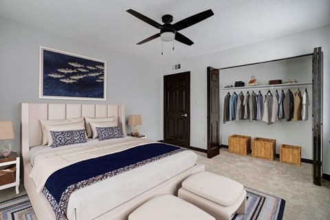 a bedroom with a bed and a ceiling fan