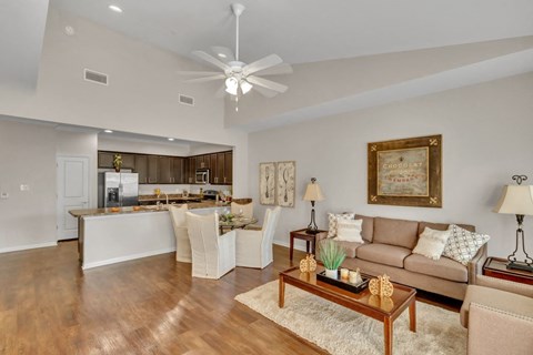 A living room with a brown couch and a wooden coffee table.