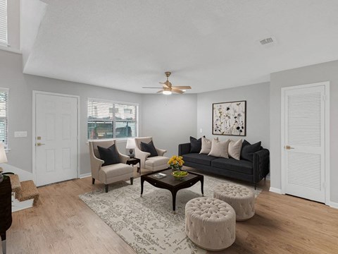 a living room with a couch and a ceiling fan