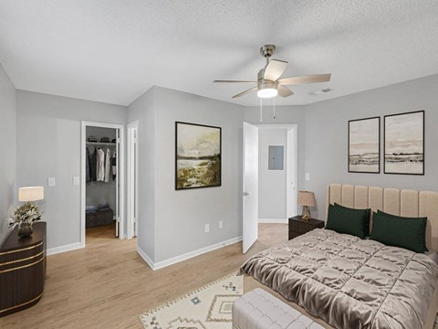 a bedroom with a bed and a ceiling fan