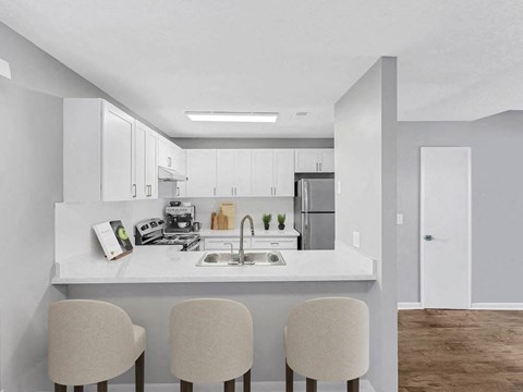 a kitchen with a sink and three chairs