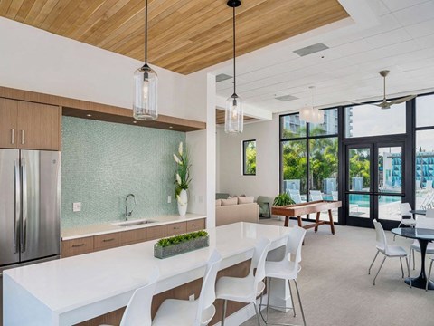 a large kitchen with a white table and chairs
