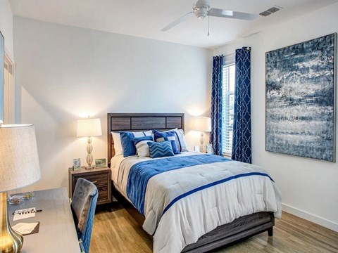 a bedroom with a bed and a ceiling fan