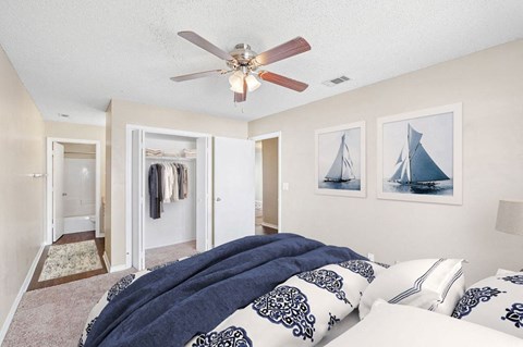 a bedroom with a bed and a ceiling fan