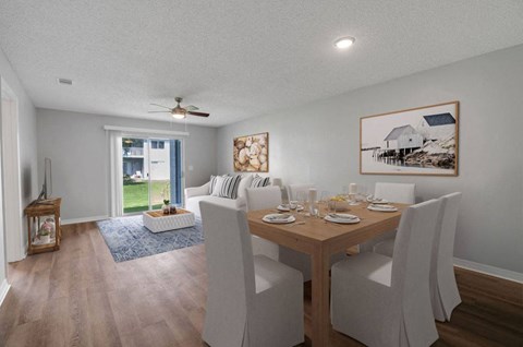 a dining room and living room with a table and chairs
