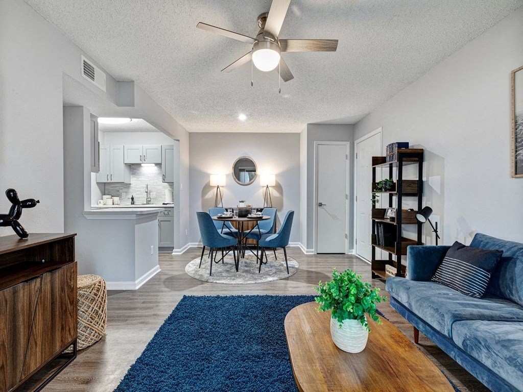 a living room and dining room with a ceiling fan at The Emory, Florida, 32514