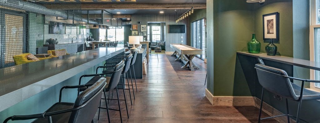 a long bar in a restaurant with chairs at Fitzroy Grove, Rogers, AR, 72758