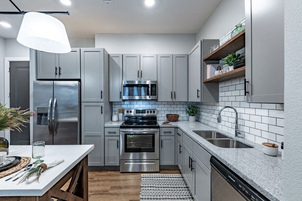 a kitchen with white cabinets and stainless steel appliances at Fitzroy Grove, Rogers, AR, 72758