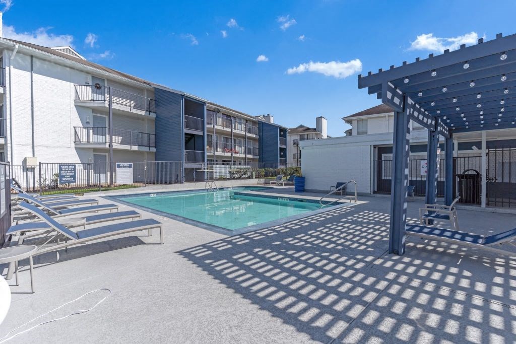 Pool and covered area with lounge chairs at Latitude 2976, Houston, TX 77042