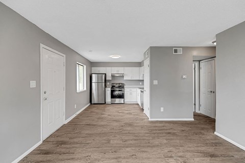 a long hallway with a kitchen in the middle