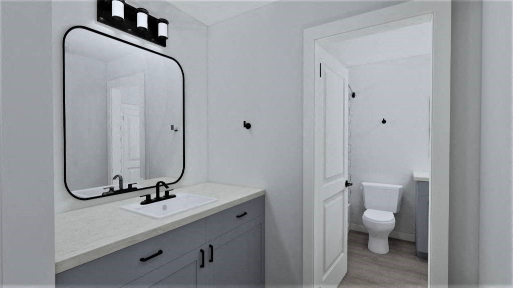 a bathroom with a mirror and a sink and a toilet