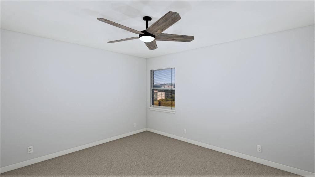 an empty room with a ceiling fan and a window