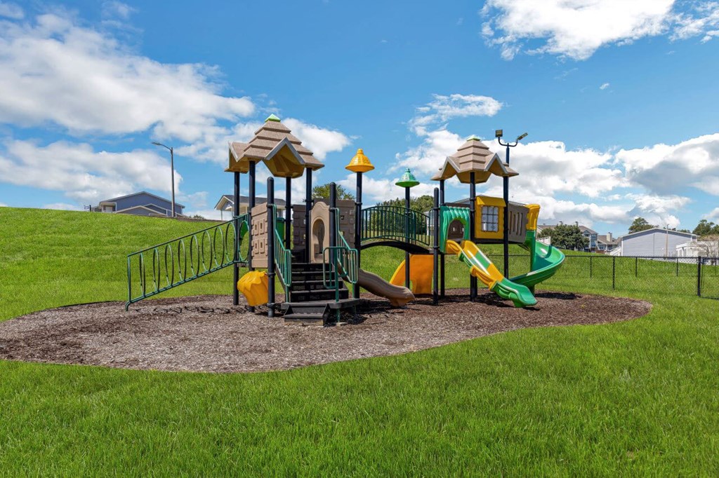 a playground with a slide and other toys in a park at The Lorient Apartments, Florida, 32514