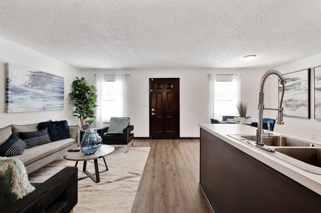 a living room with a couch and a sink at The Lorient Apartments, Pensacola, Florida