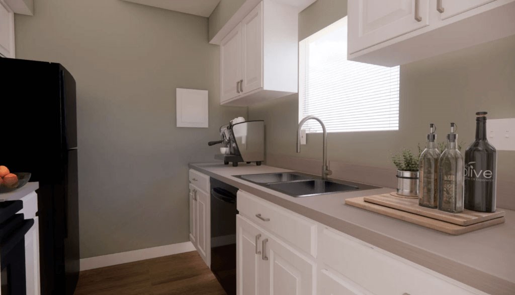 A kitchen with white cabinets and a black refrigerator.