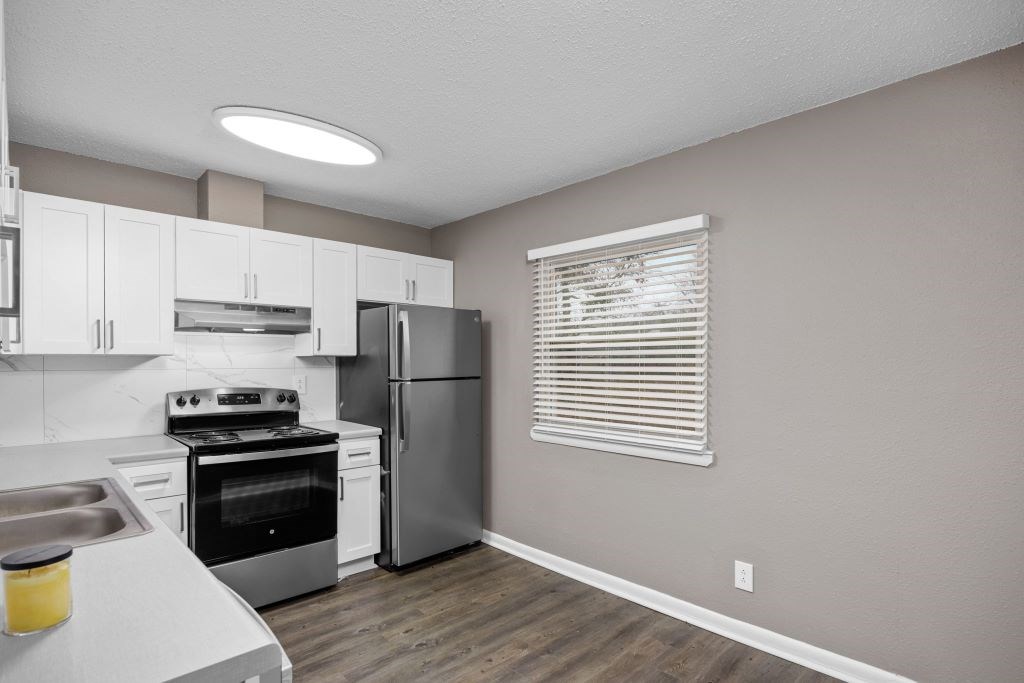 A kitchen with a stove, oven, and refrigerator.