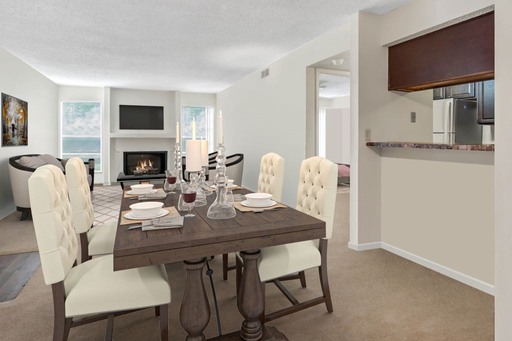 A dining room with a wooden table and white chairs.