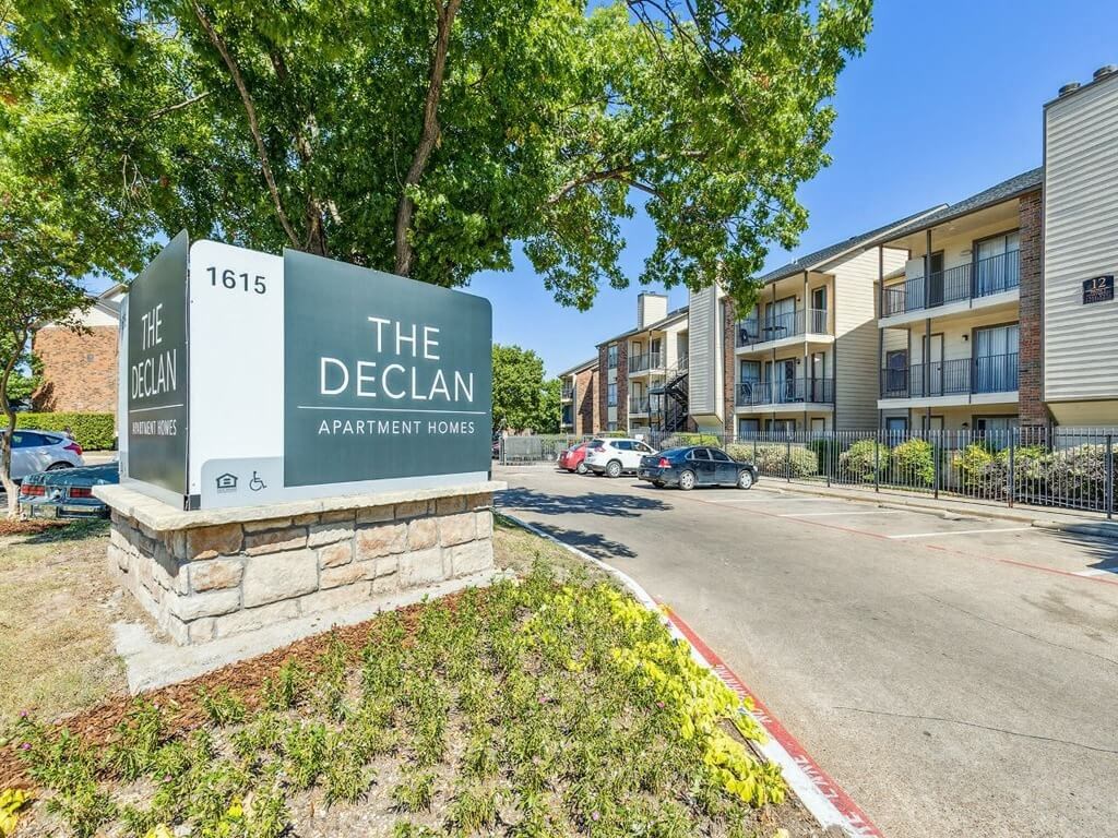 an apartment building with a sign that reads the decan apartments entrance