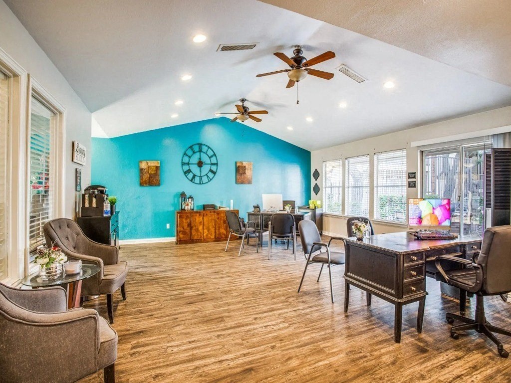a living room with a blue wall and a dining room table and chairs