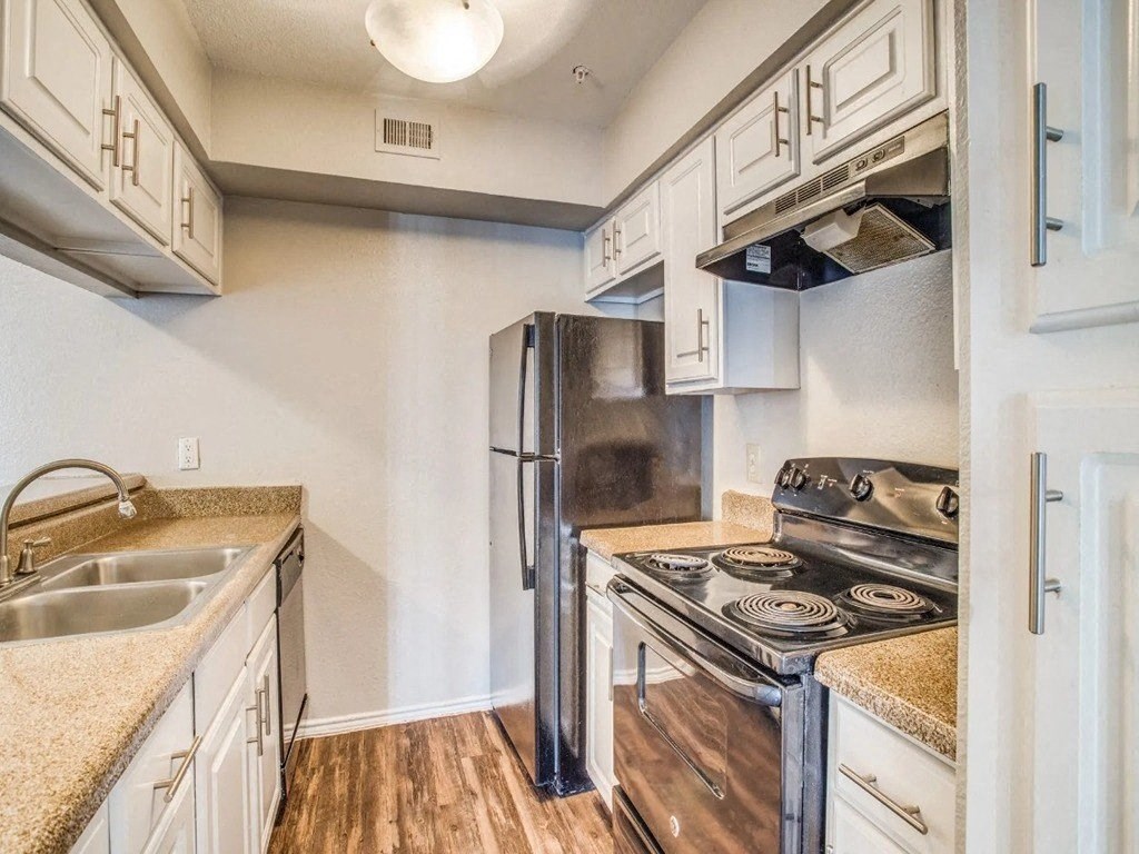 a kitchen with a stove and a refrigerator