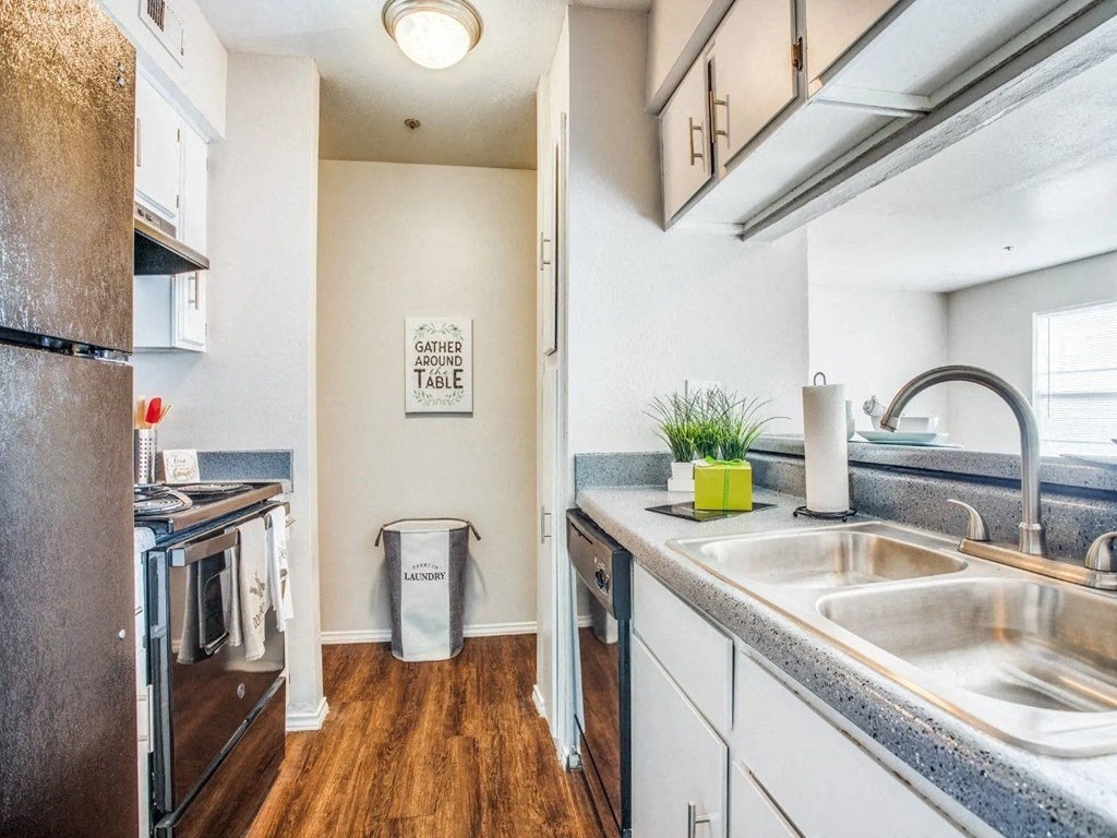 a kitchen with a sink and a stove and a refrigerator