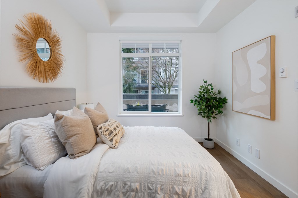 A bedroom with a large bed and a mirror on the wall.