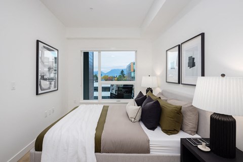 a bedroom with a large bed and a large window