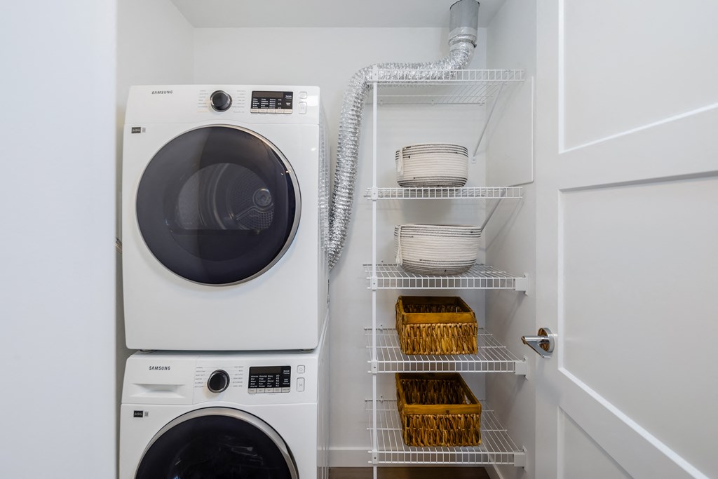 A white washing machine and dryer in a laundry room.