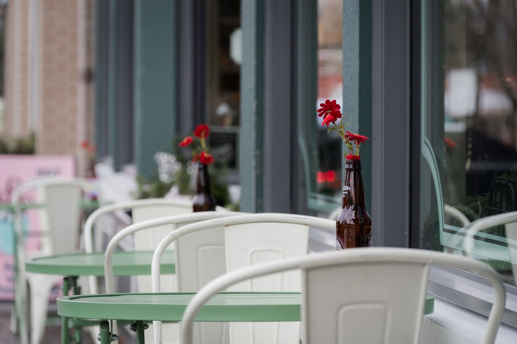 A table with a vase of flowers on it.