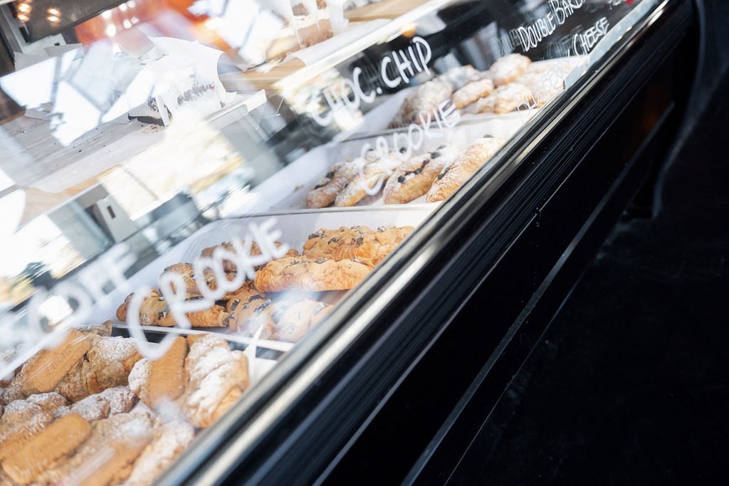 A display case filled with assorted cookies and pastries.
