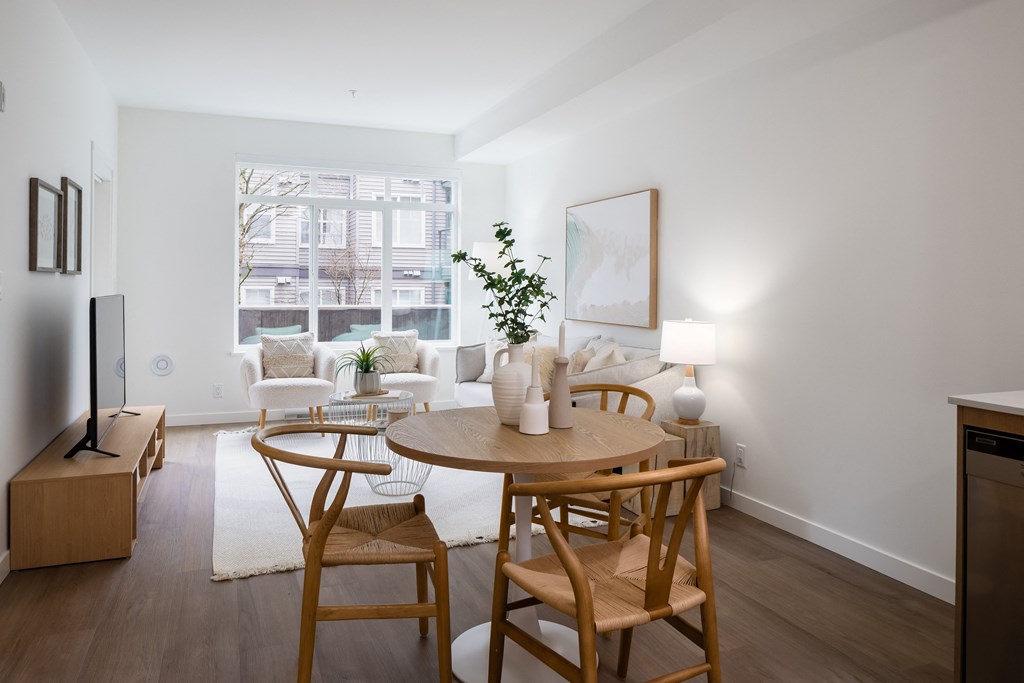 A modern dining room with a wooden table and chairs.