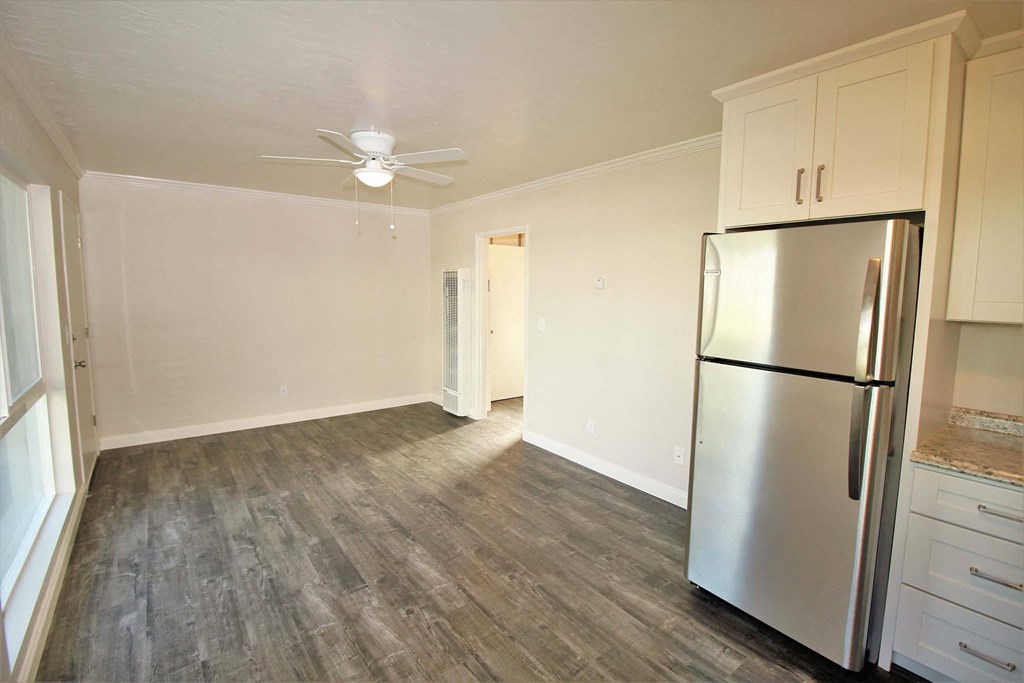 a kitchen with a stainless steel refrigerator and white cabinets