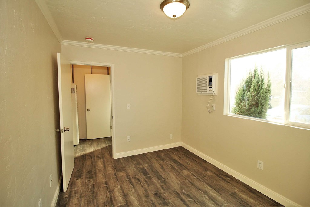 an empty room with a window and a door