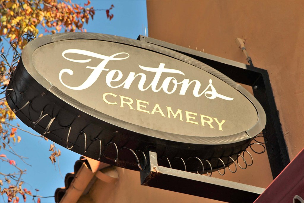a sign for fountain creamery on the side of a building