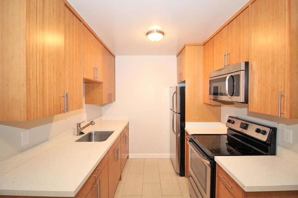 full kitchen with stainless steel appliances and wood cabinets