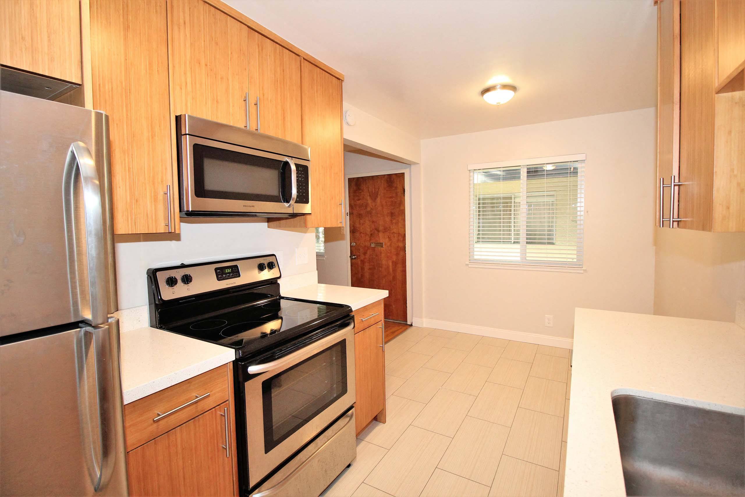 a kitchen with stainless steel appliances and wooden cabinets