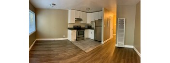 a kitchen with white cabinets and a stainless steel refrigerator