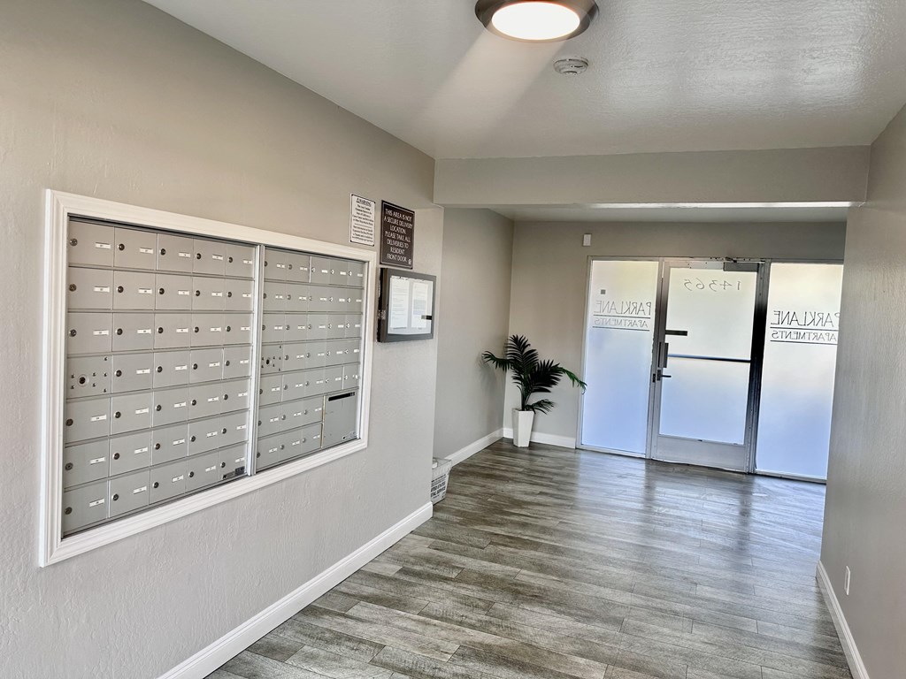 a lockers room in a building with a door and a plant