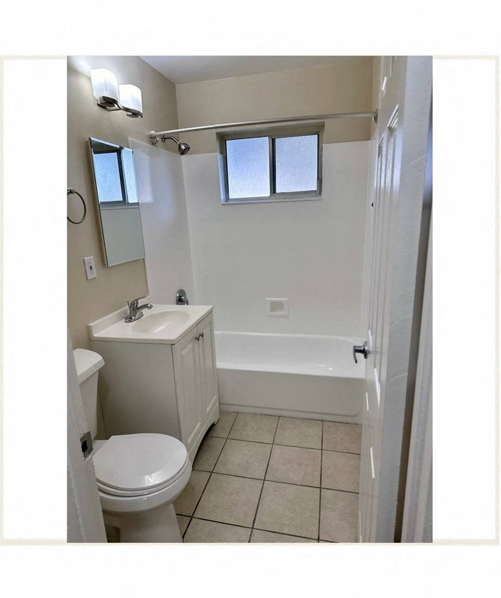 a bathroom with a toilet sink and a bath tub