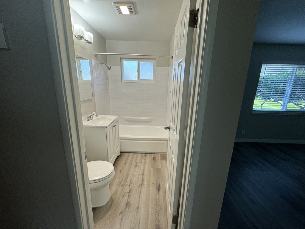 a small bathroom with a toilet and a bath tub
