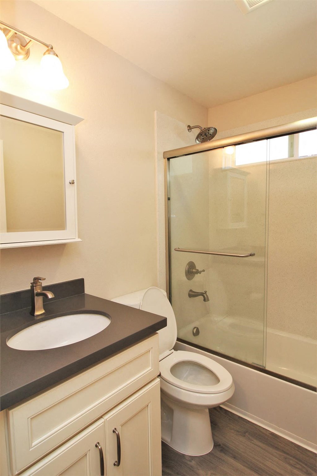 a bathroom with a shower and a sink and a toilet