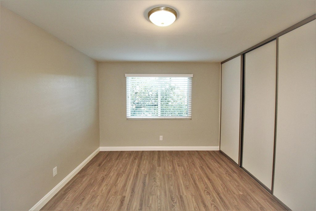 an empty room with white walls and a window