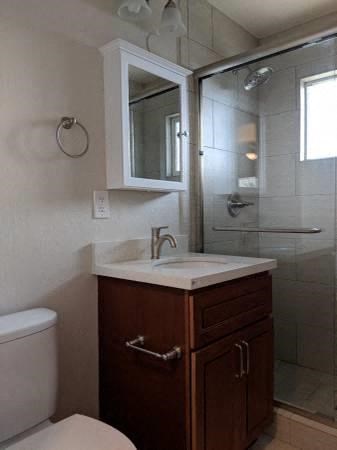a bathroom with a toilet and a sink and a shower